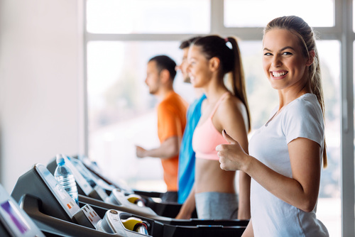 Group of friends exercising on treadmill machine Group of friends exercising on treadmill machine